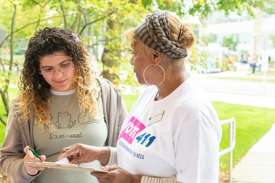 A LWV volunteer registering someone to vote