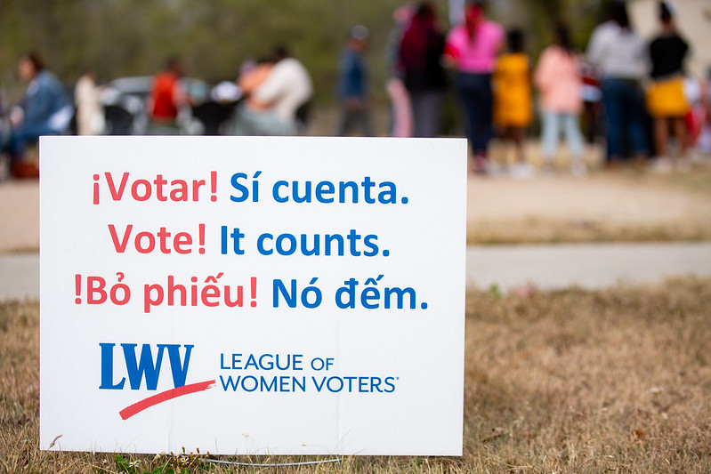 LWV sign that says "Vote! It counts" in three languages