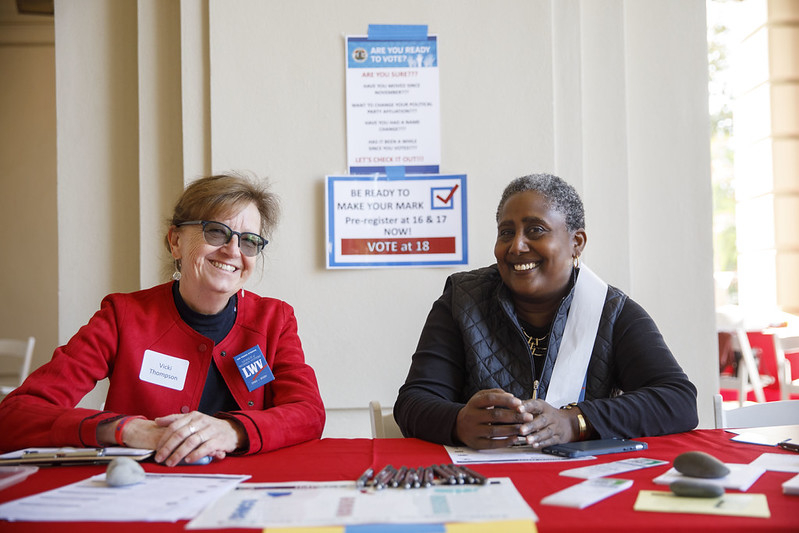 Two League members at a voter registration table