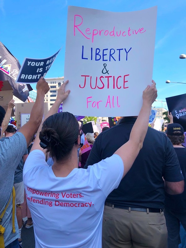 A League member holding a sign that says