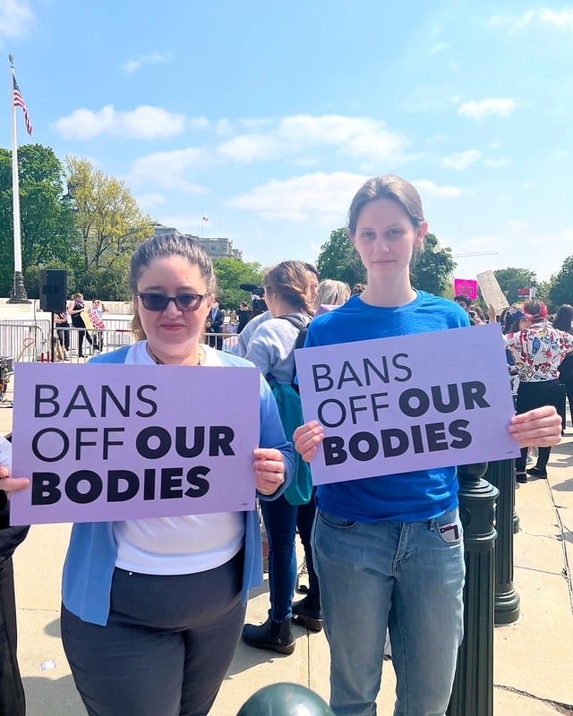 LWV staff at a reproductive rights rally holding 