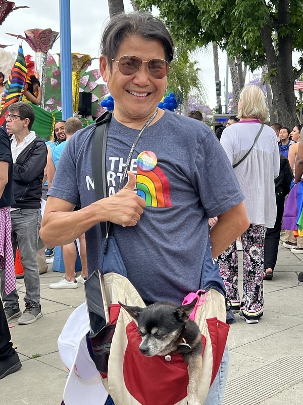 Man wearing a a rainbow flag pin