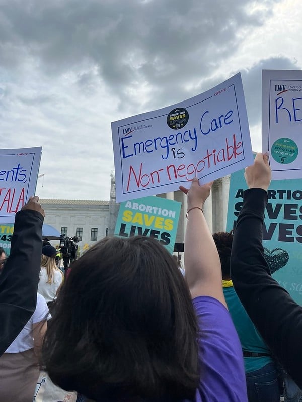 LWV member holding a sign that says 