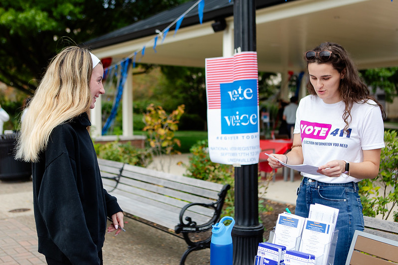 A woman registering another young woman to vote