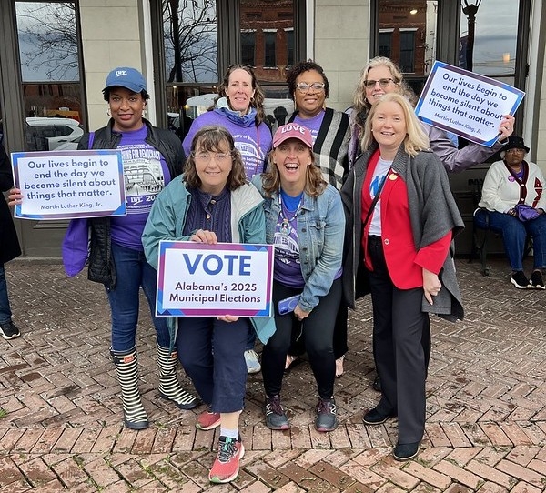 LWV members, including CEO Celina Stewart and President Dianna Wynn, holding signs promoting voting