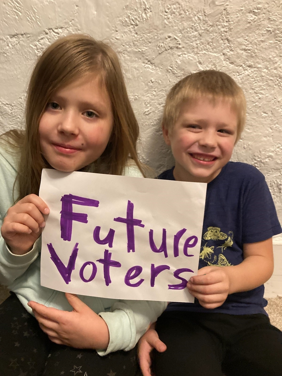 The author's children holding a sign that says