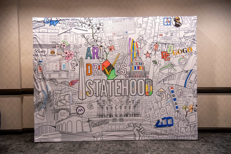 A large art piece depicting DC cultural icons with the words "Art Drives Statehood"