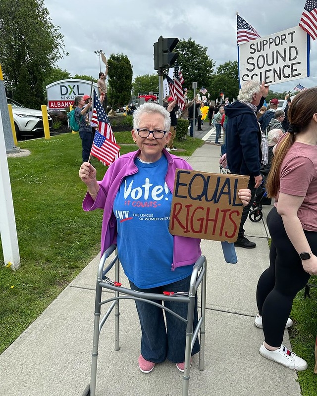 A league member holding a sign that says
