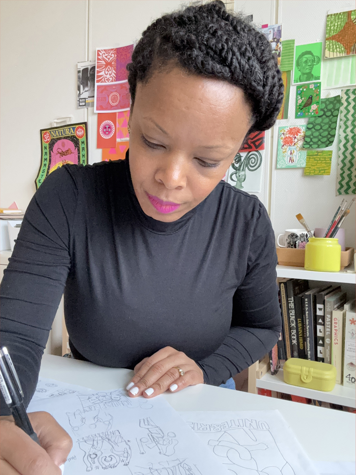 A woman drawing on a large, white pad