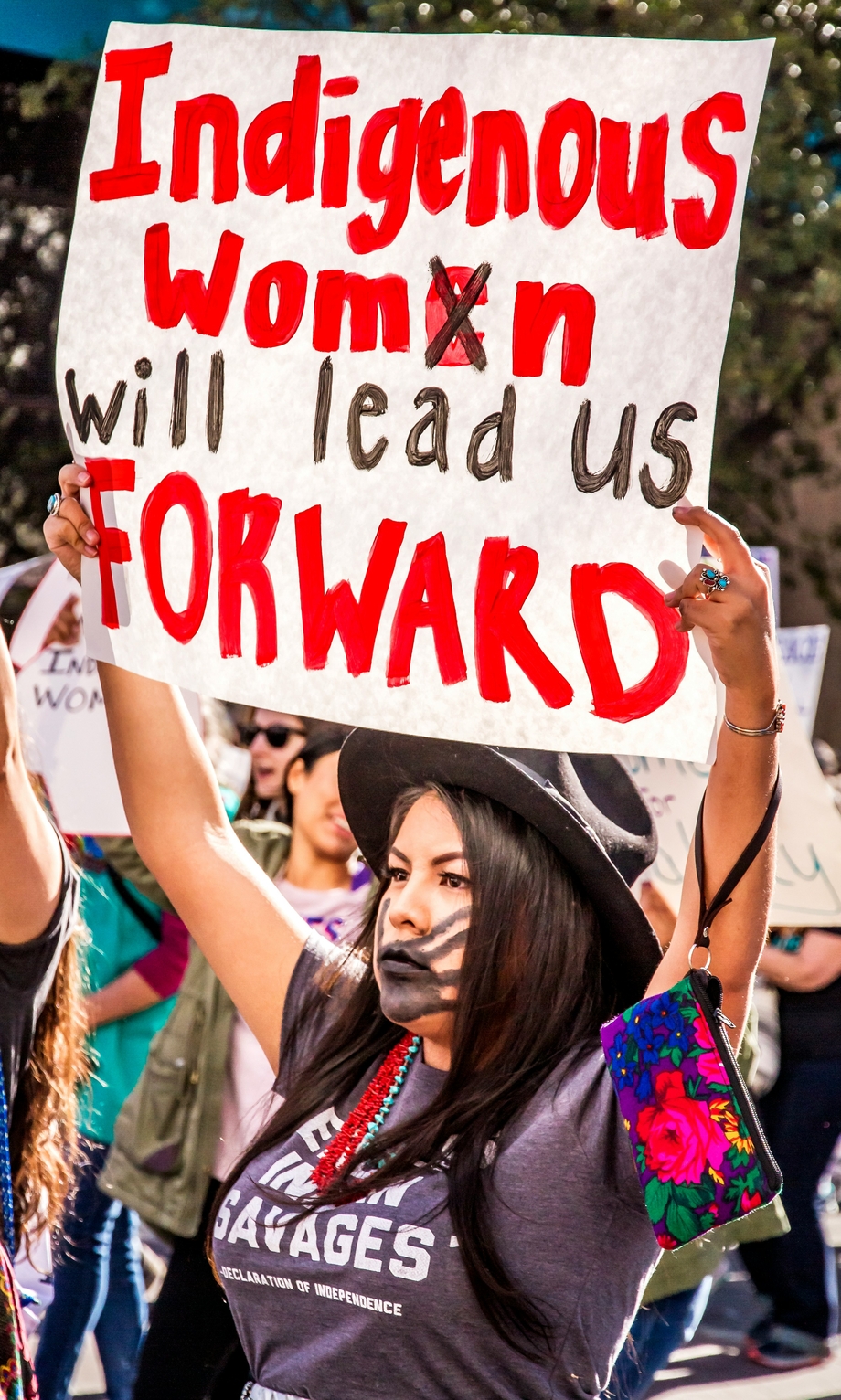 A woman holding a sign saying 