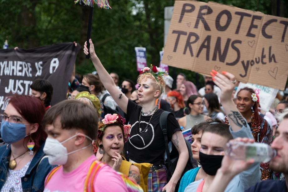 Protestors, one of whom holds a sign that says 