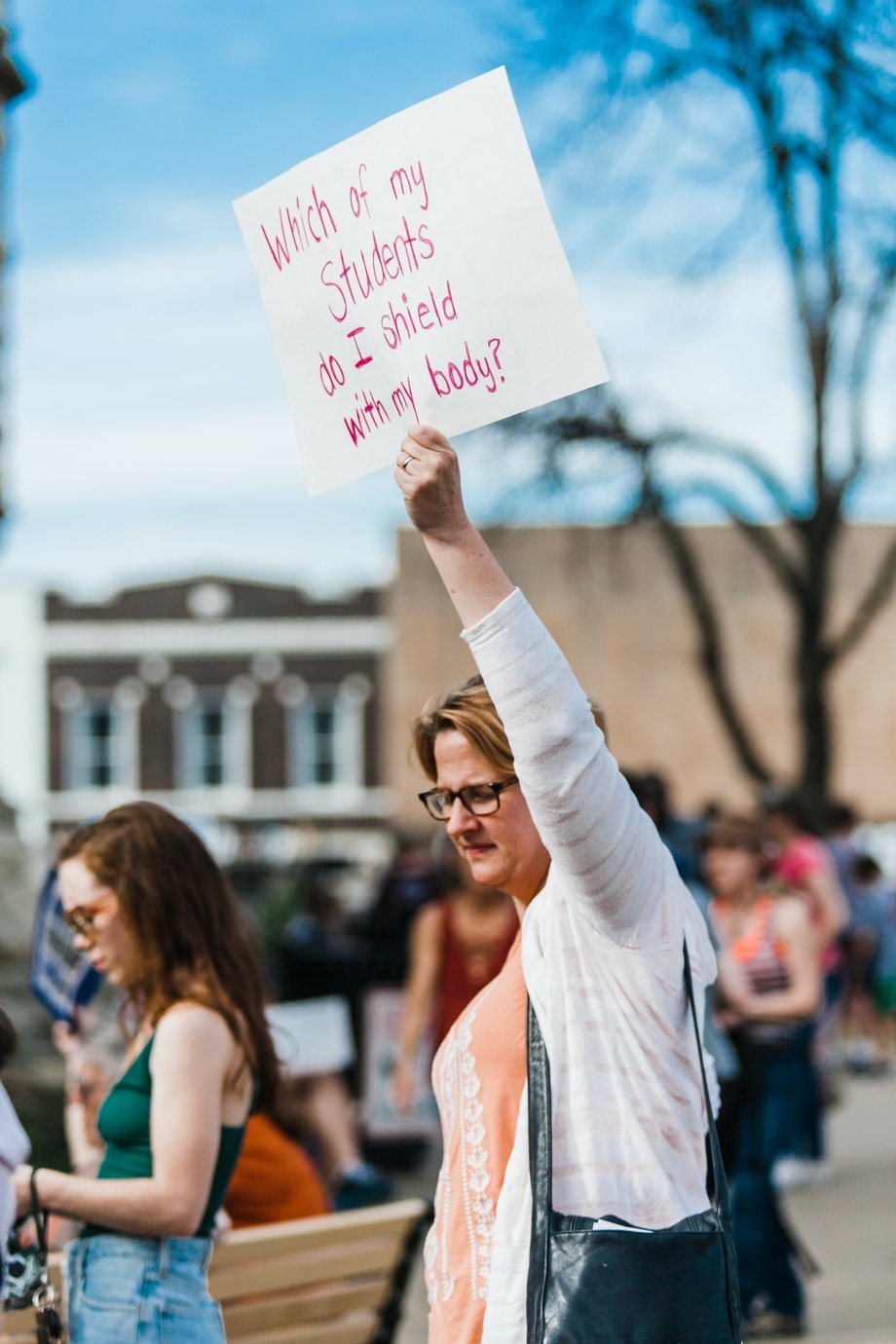 Woman holding a sign saying 