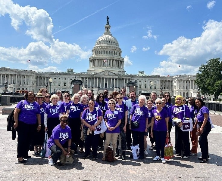 League members standing in front of the US Capitol on a sunny day