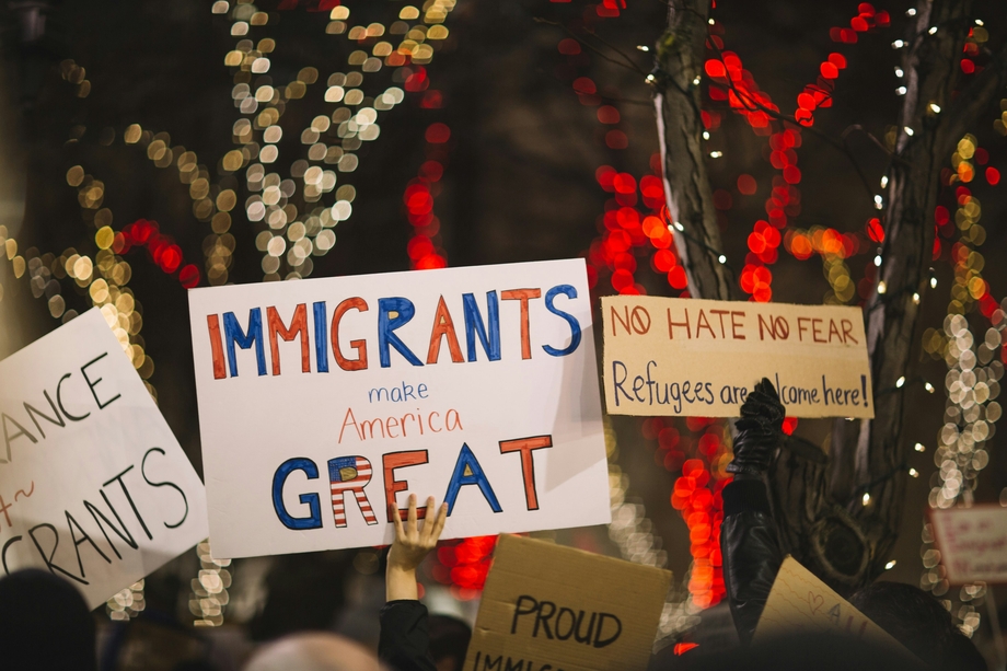 Protestors holding up pro-immigration signs such as 