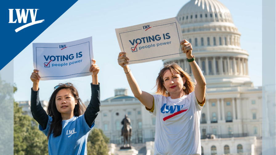 Two women holding up voting rights signs outside the US Capitol